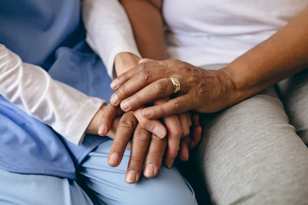 A close up of two people holding hands