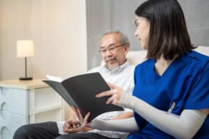 A man and woman sitting in front of an open book.